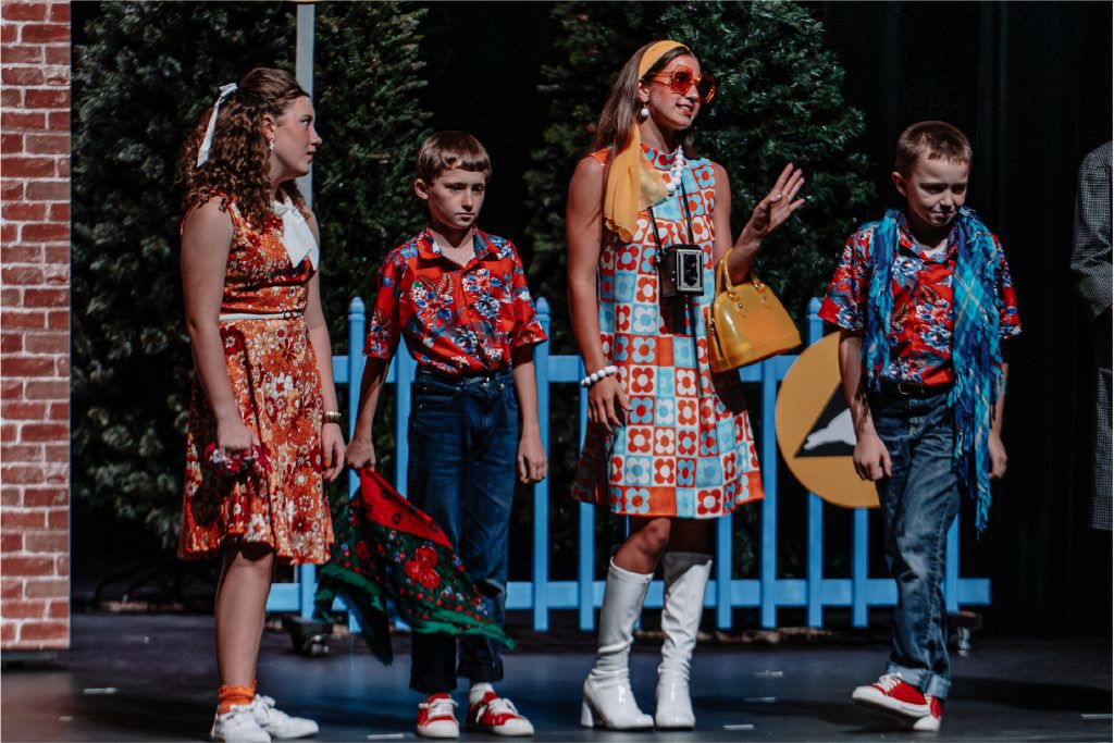 Group of young actors and actresses performing a play set in Communist Soviet Union.
